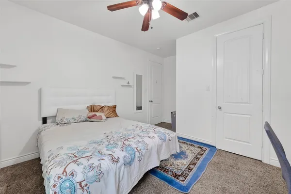 a bedroom with a bed and a lamp