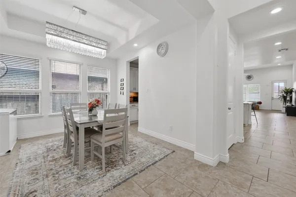 a dining room with furniture and a view of kitchen