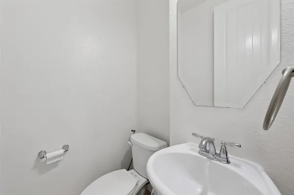 a white toilet sitting next to a white sink