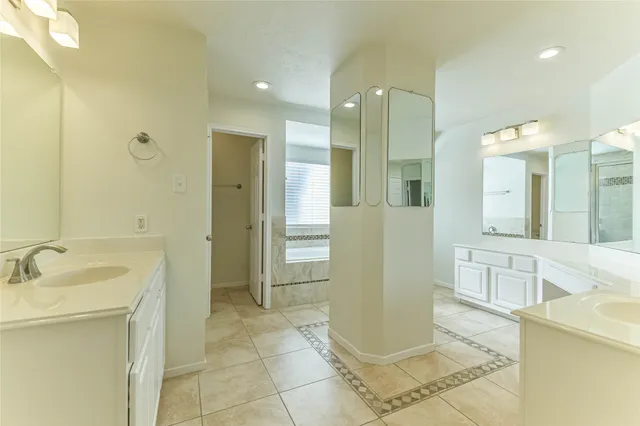 a white bath tub sitting next to a shower