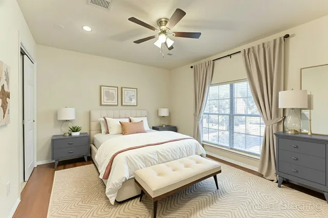 an empty room with a window and a ceiling fan