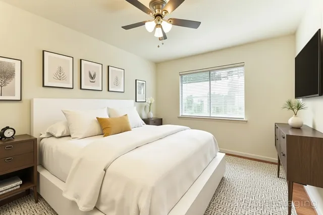 an empty room with a window and a ceiling fan