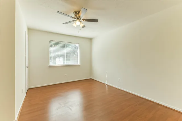 a living room with patio furniture and a potted plant