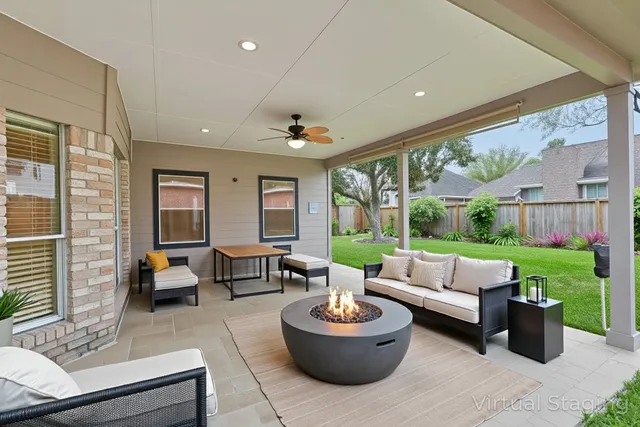 a view of a house with a backyard porch and sitting area