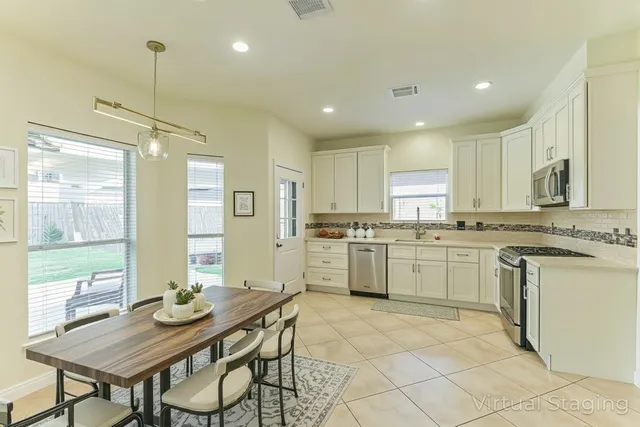 a kitchen with a sink window and cabinets