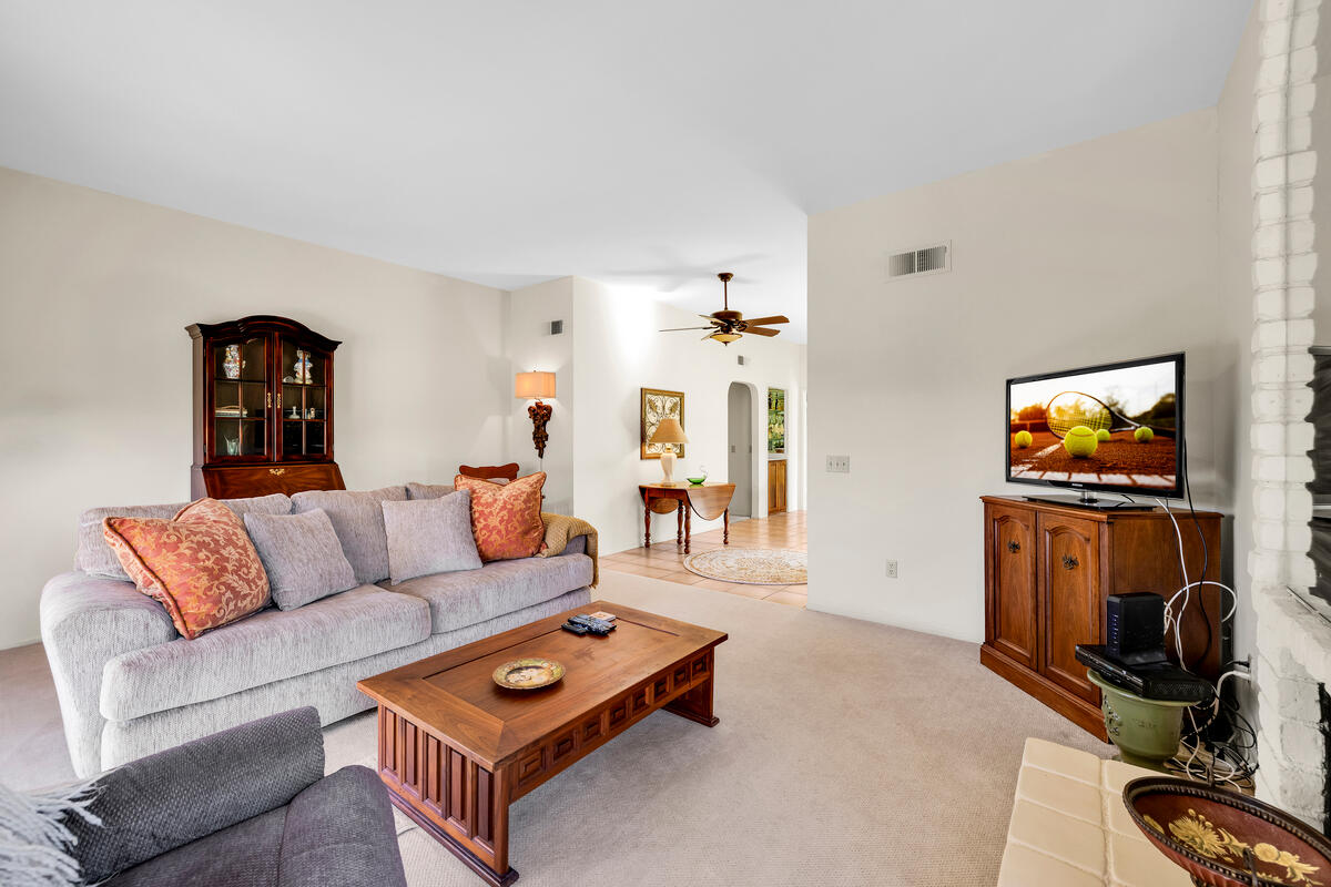 44149 Chamonix Court Palm Desert, CA 92260 - Photo 11 of 50 a living room with furniture and a flat screen tv