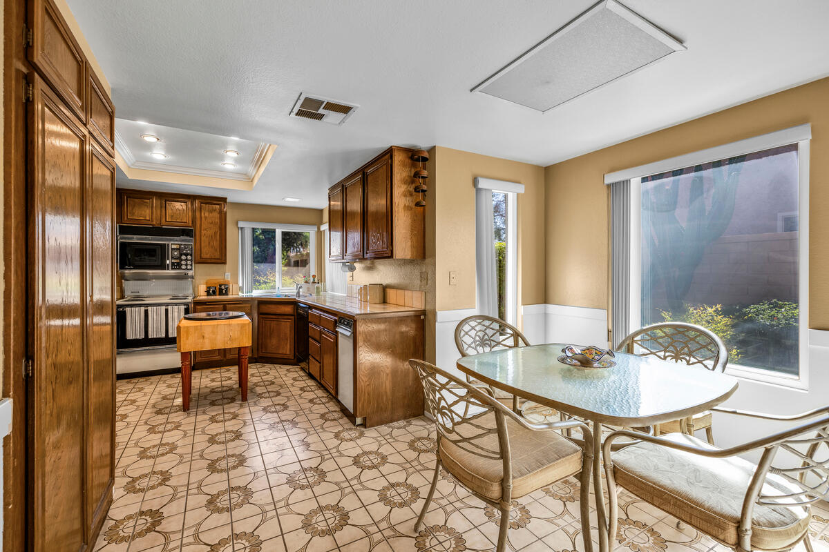 44149 Chamonix Court Palm Desert, CA 92260 - Photo 13 of 50 a kitchen with a table and chairs in it
