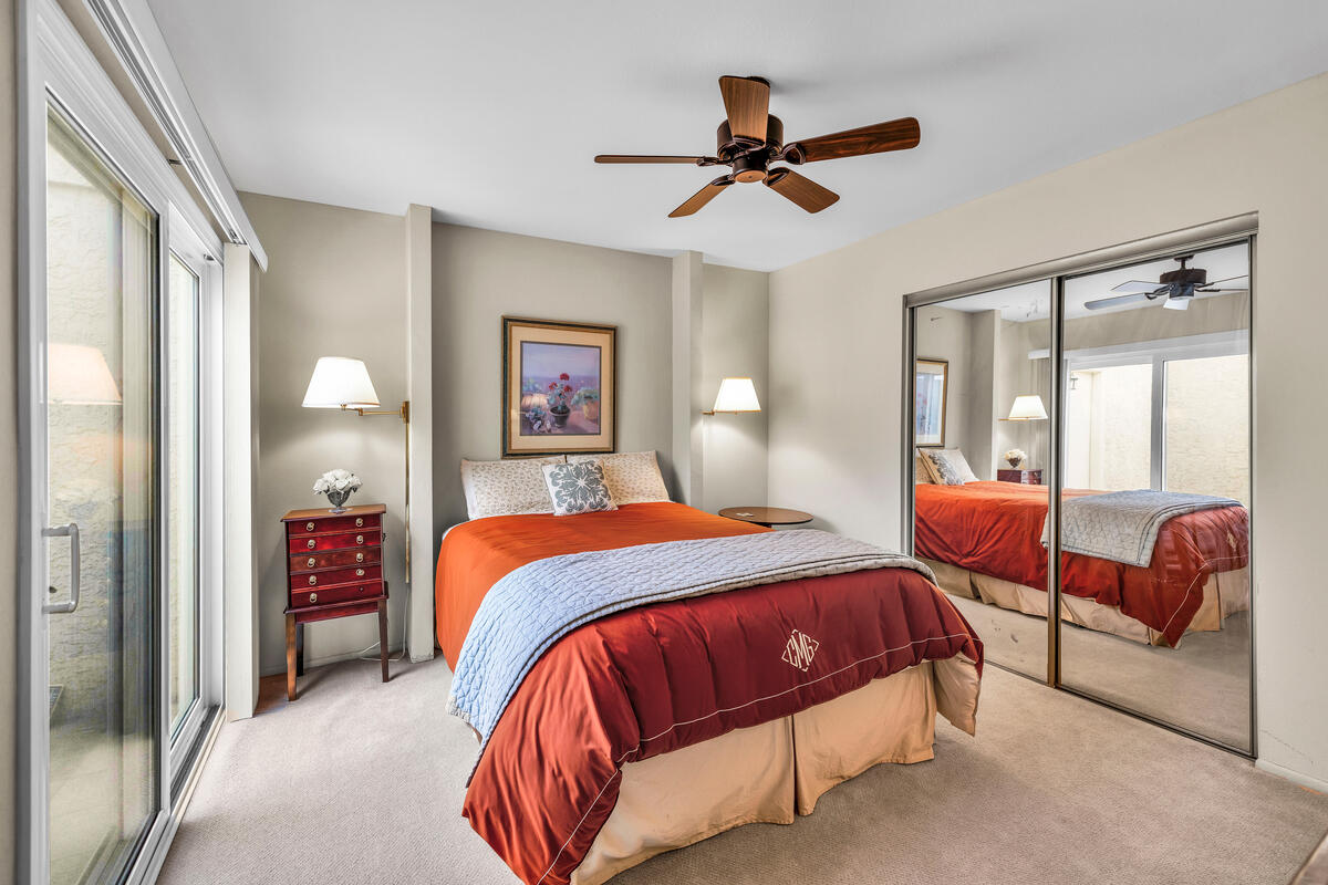 44149 Chamonix Court Palm Desert, CA 92260 - Photo 18 of 50 a bedroom with a bed and dresser with mirror