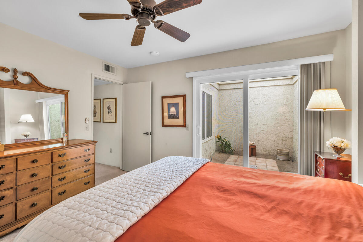 44149 Chamonix Court Palm Desert, CA 92260 - Photo 19 of 50 a bedroom with a bed and a dresser