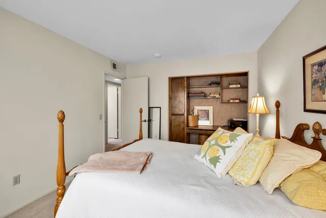 a bedroom with a bed and a lamp on table