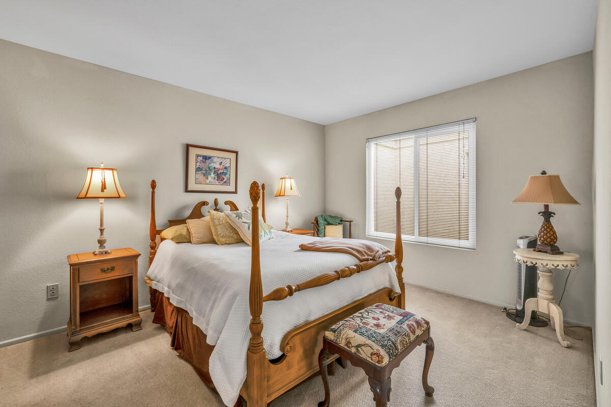 44149 Chamonix Court Palm Desert, CA 92260 - Photo 22 of 50 a bedroom with a bed and a lamp on table