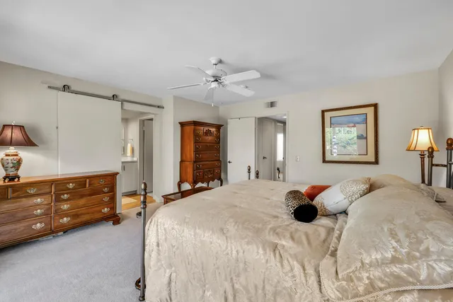 a bedroom with a bed and a table lamp