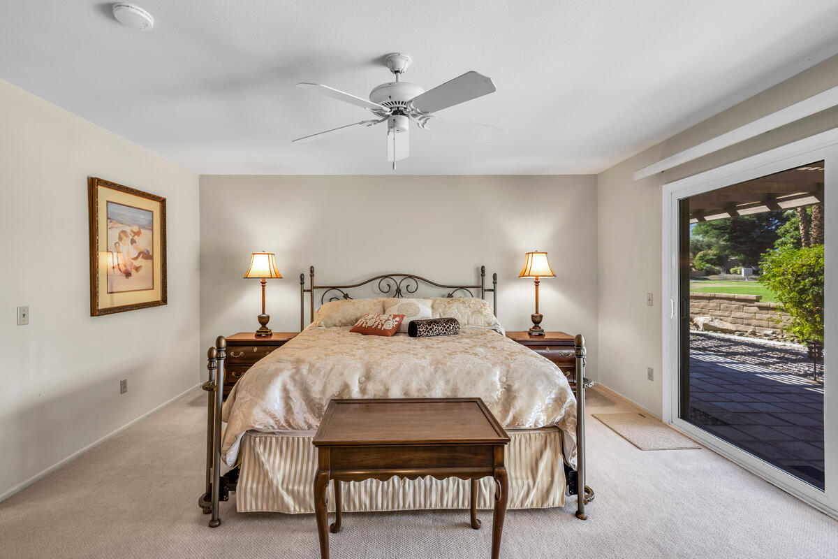 44149 Chamonix Court Palm Desert, CA 92260 - Photo 24 of 50 a bedroom with a bed and a table lamp