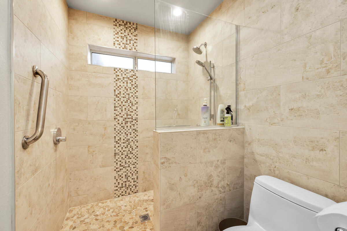 44149 Chamonix Court Palm Desert, CA 92260 - Photo 26 of 50 a bathroom with a shower toilet and a shower