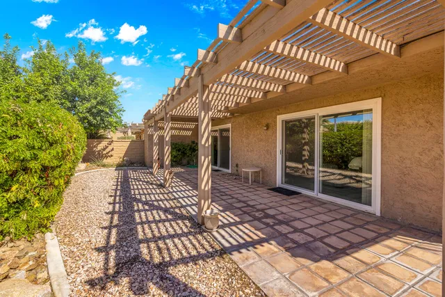 a view of a garden with a table under an umbrella
