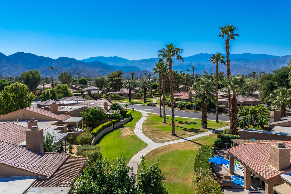 44149 Chamonix Court Palm Desert, CA 92260 - Photo 33 of 50 a view of a swimming pool with a table and chairs