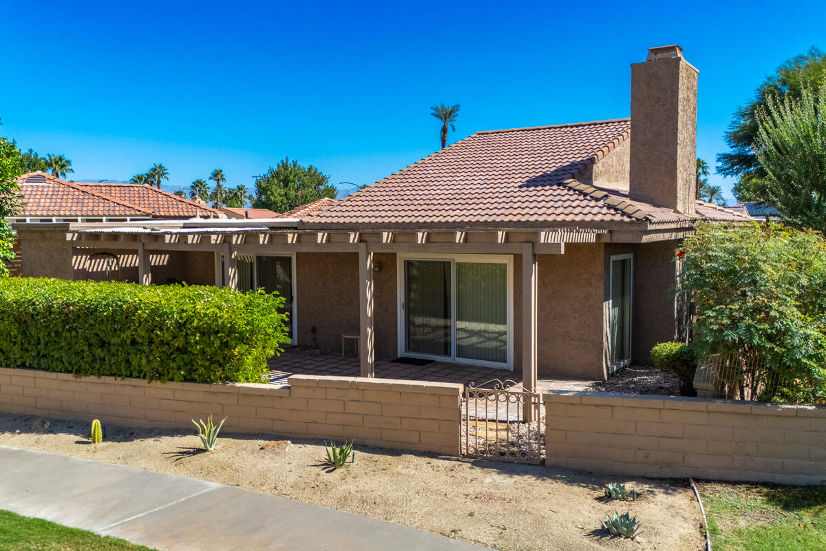 44149 Chamonix Court Palm Desert, CA 92260 - Photo 34 of 50 front view of a house with a garden