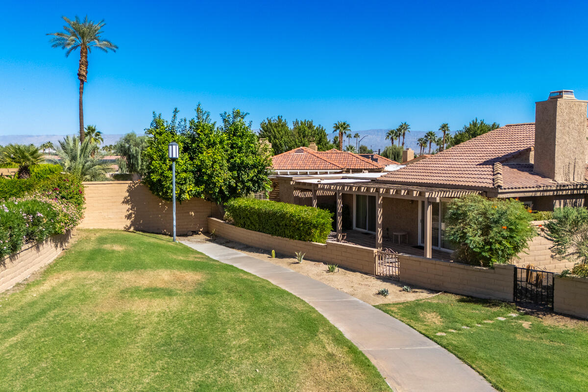 44149 Chamonix Court Palm Desert, CA 92260 - Photo 35 of 50 a front view of a house with a yard