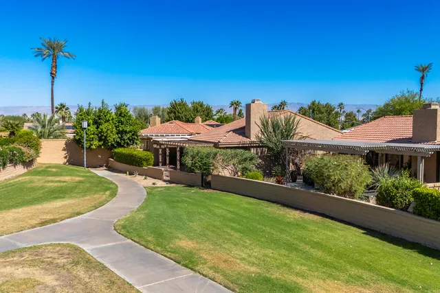 an aerial view of residential house and sandy dunes
