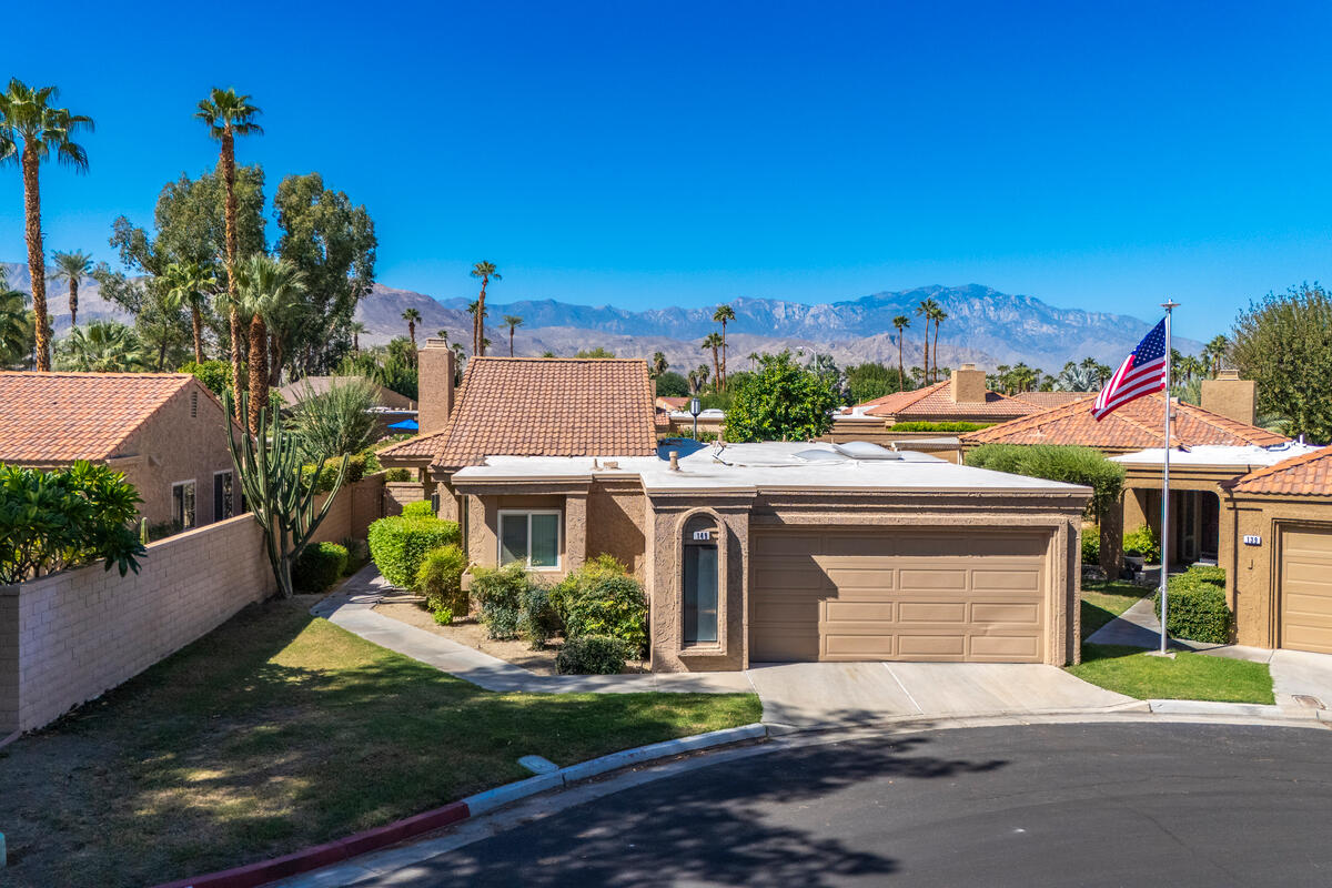 44149 Chamonix Court Palm Desert, CA 92260 - Photo 4 of 50 front view of a house with a yard