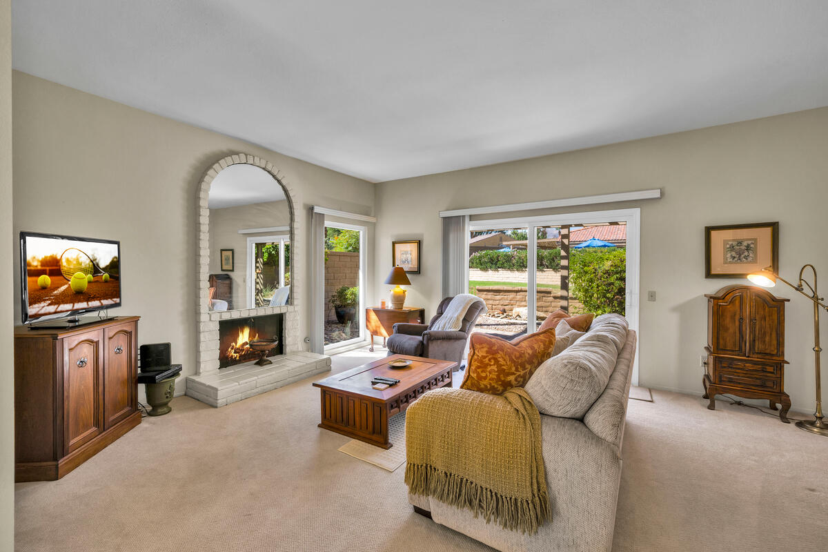 44149 Chamonix Court Palm Desert, CA 92260 - Photo 6 of 50 a living room with furniture and a flat screen tv