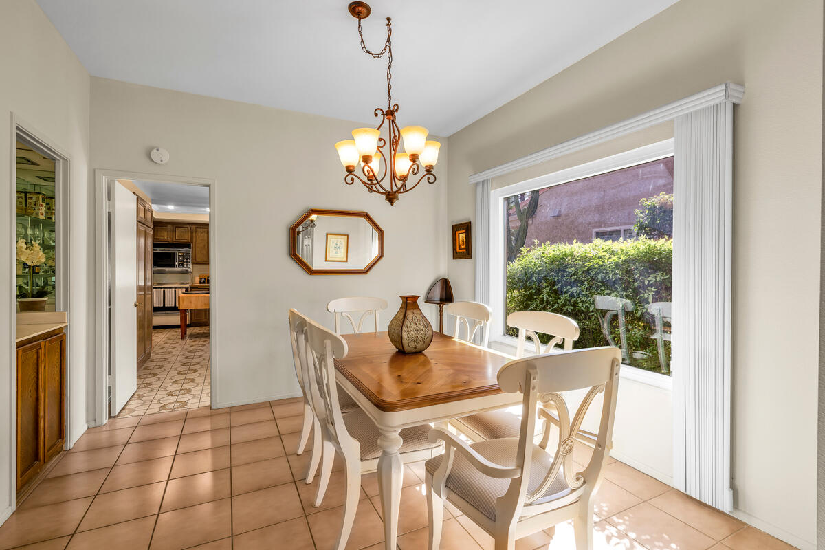 44149 Chamonix Court Palm Desert, CA 92260 - Photo 9 of 50 a dining room with furniture a chandelier and window