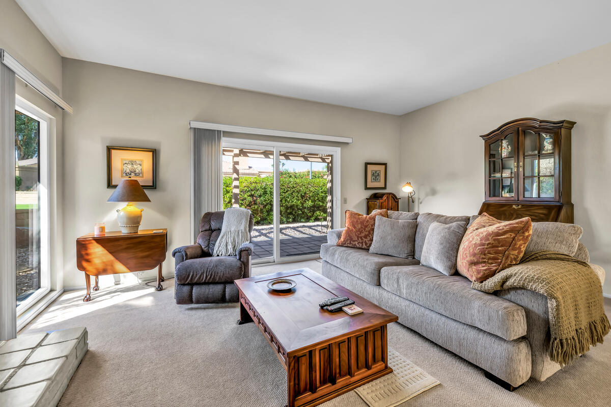 44149 Chamonix Court Palm Desert, CA 92260 - Photo 10 of 50 a living room with furniture and a large window