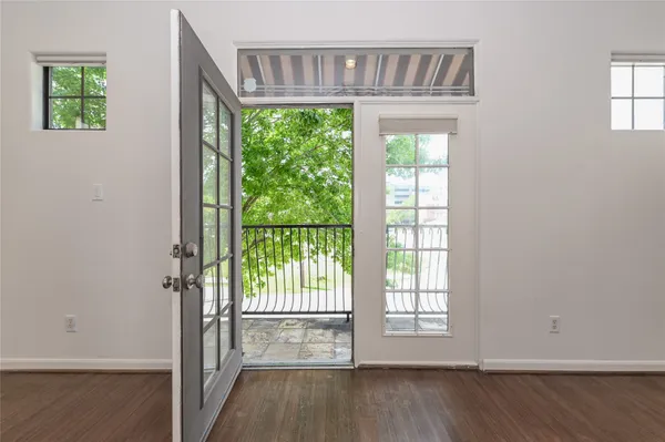 a view of an entryway with wooden floor