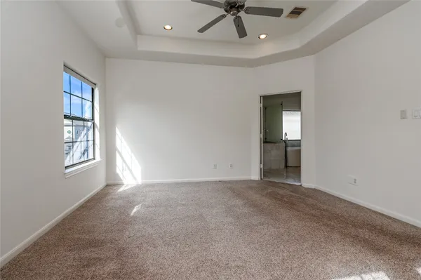 an empty room with windows and cabinet