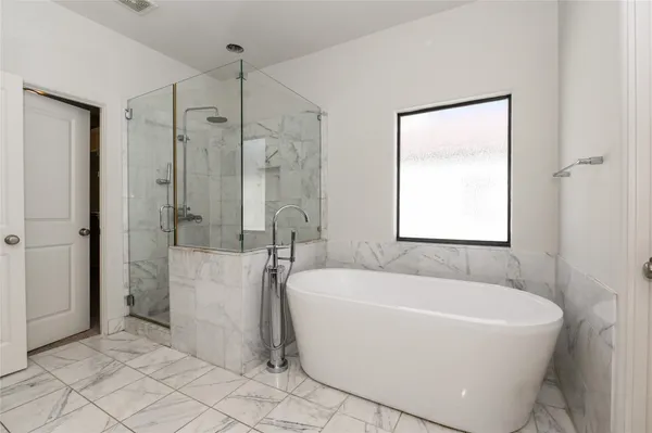 a white bath tub sitting next to a white sink