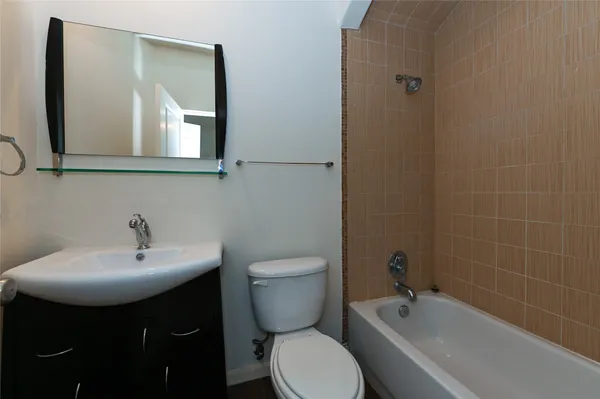 a bathroom with a sink toilet and mirror