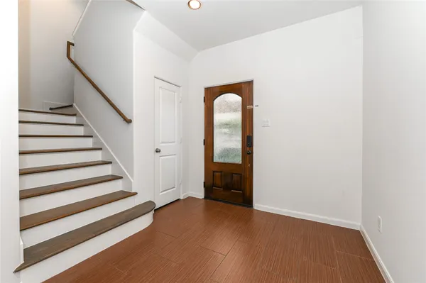 a view of a room with wooden floor and stairs