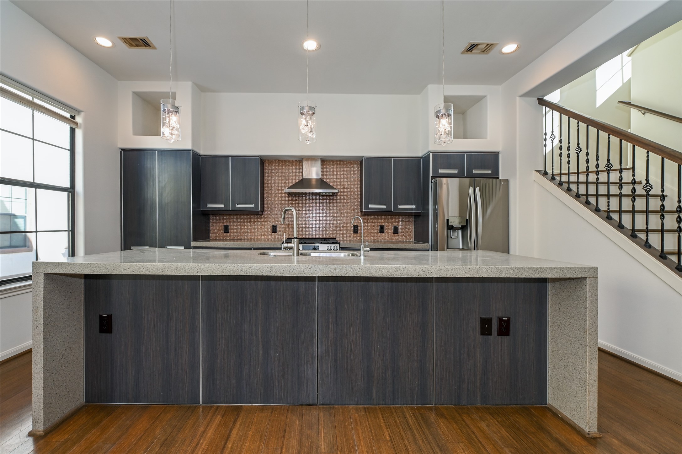 3948 Feagan Street Houston, TX 77007 - Photo 5 of 30 a kitchen with stainless steel appliances a sink cabinets and wooden floor