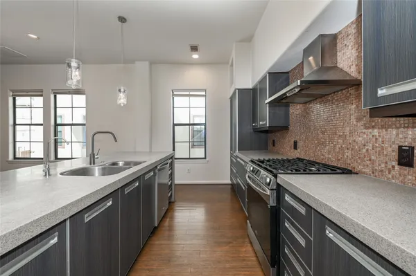 a kitchen with a sink stove and cabinets
