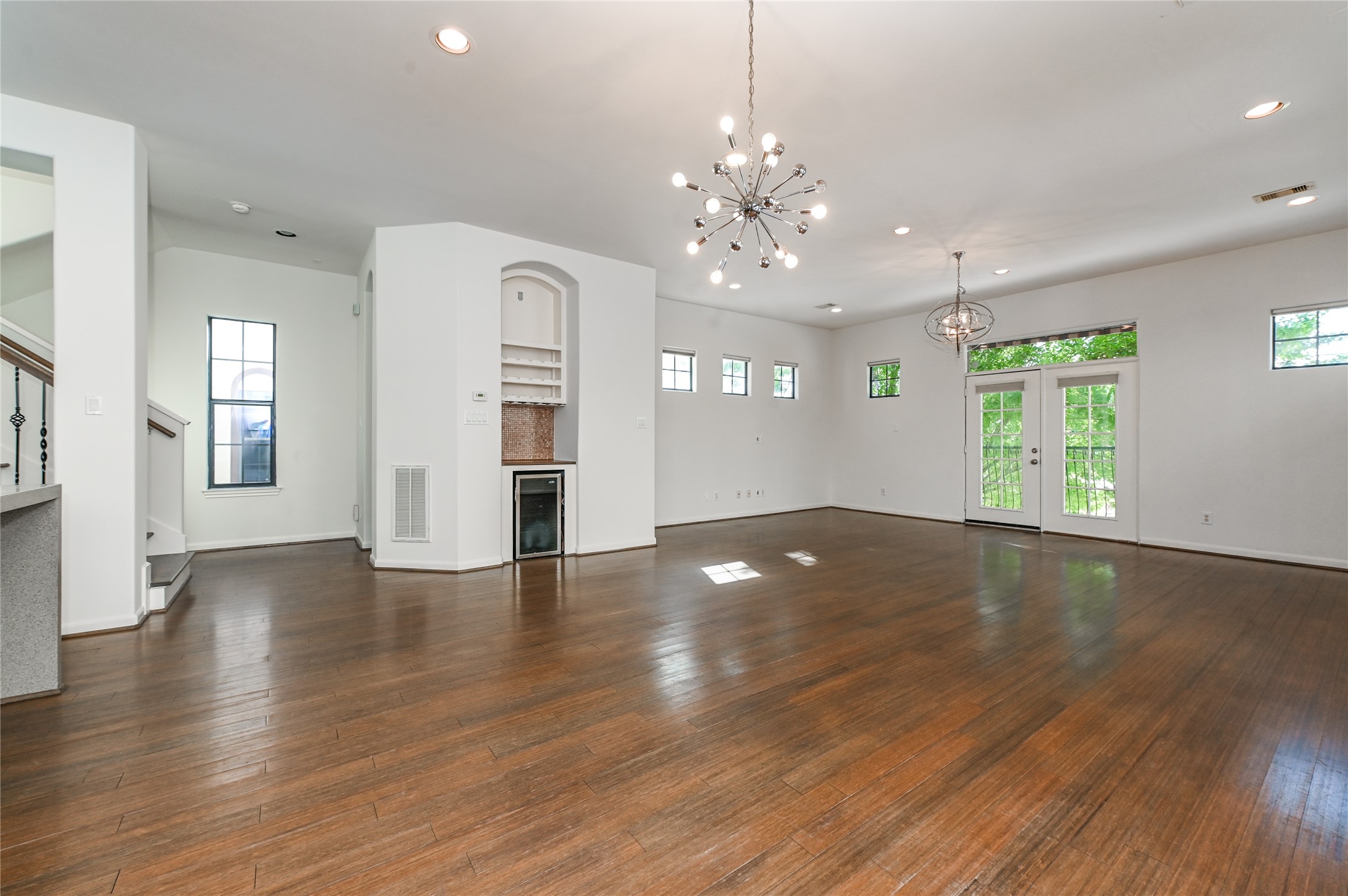 3948 Feagan Street Houston, TX 77007 - Photo 10 of 30 an empty room with wooden floor and large windows