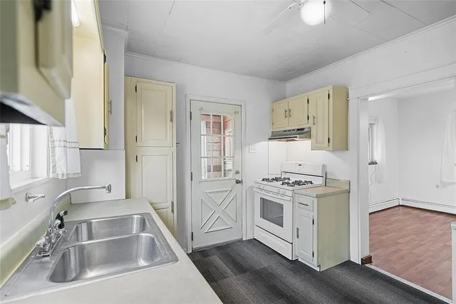 a kitchen with stainless steel appliances granite countertop a sink stove and a refrigerator