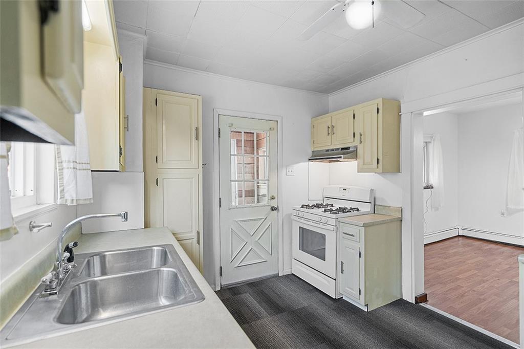404 1/2 Franklin Avenue Vandergrift, PA 15690 - Photo 14 of 31 a kitchen with stainless steel appliances granite countertop a sink stove and a refrigerator