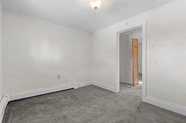 an empty room with closet and window