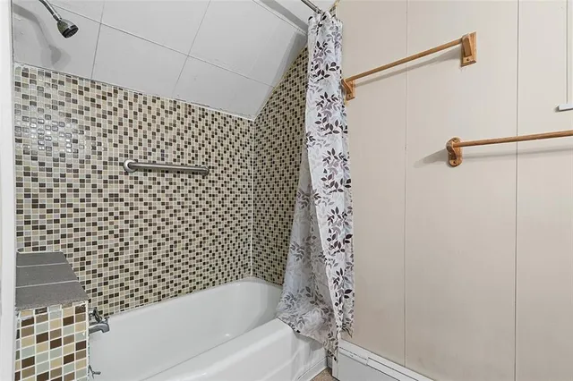 a bathroom with a bathtub and shower