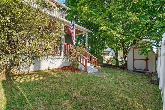 a view of a house with a yard and deck