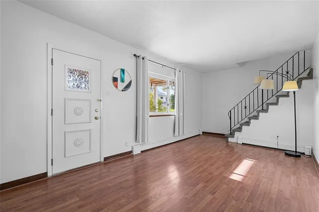 a view of an entryway with wooden floor