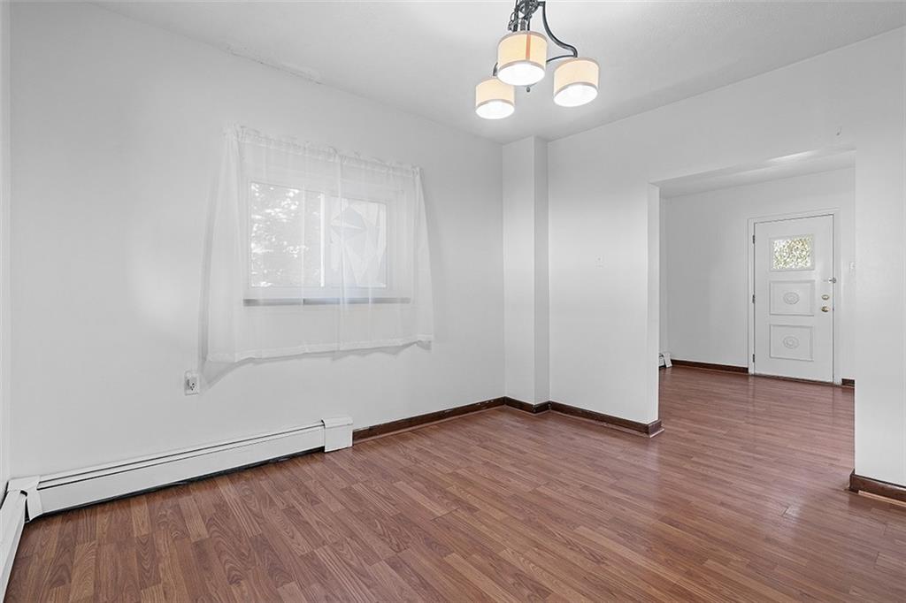 404 1/2 Franklin Avenue Vandergrift, PA 15690 - Photo 6 of 31 an empty room with wooden floor cabinet and windows