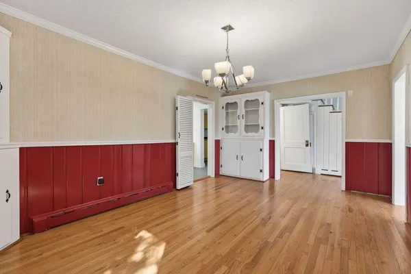 a view of an empty room with a fireplace and a window