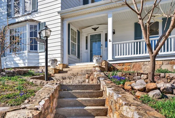 a front view of a house with outdoor seating and plants