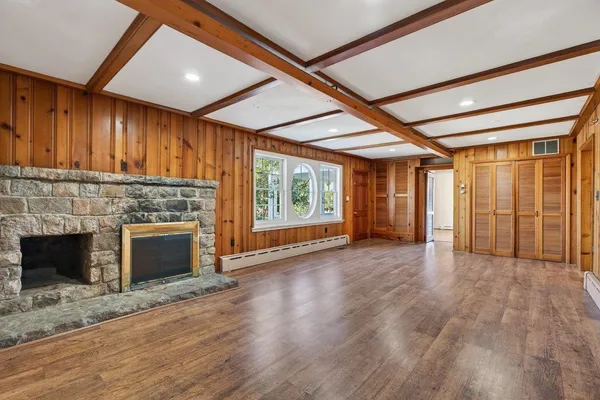 a living room with furniture a large window and a flat screen tv