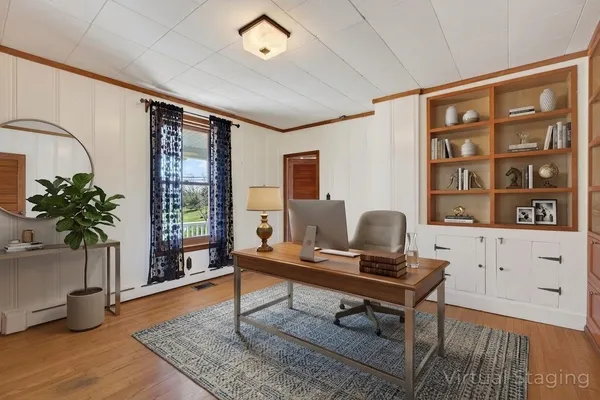 a view of a porch with wooden floor and iron fence