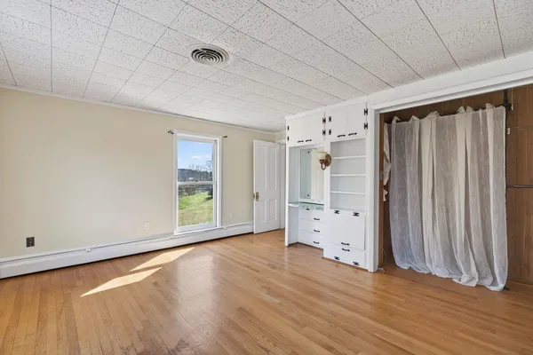 a front view of a house with a yard and potted plants
