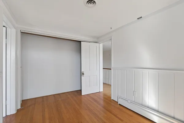 an aerial view of a house with a garden and lake view