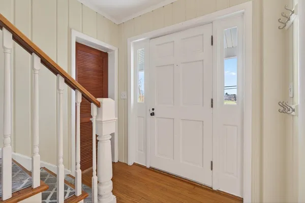 a view of entryway with wooden floor and stairs