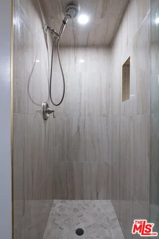 a living room with fireplace furniture and a book shelf